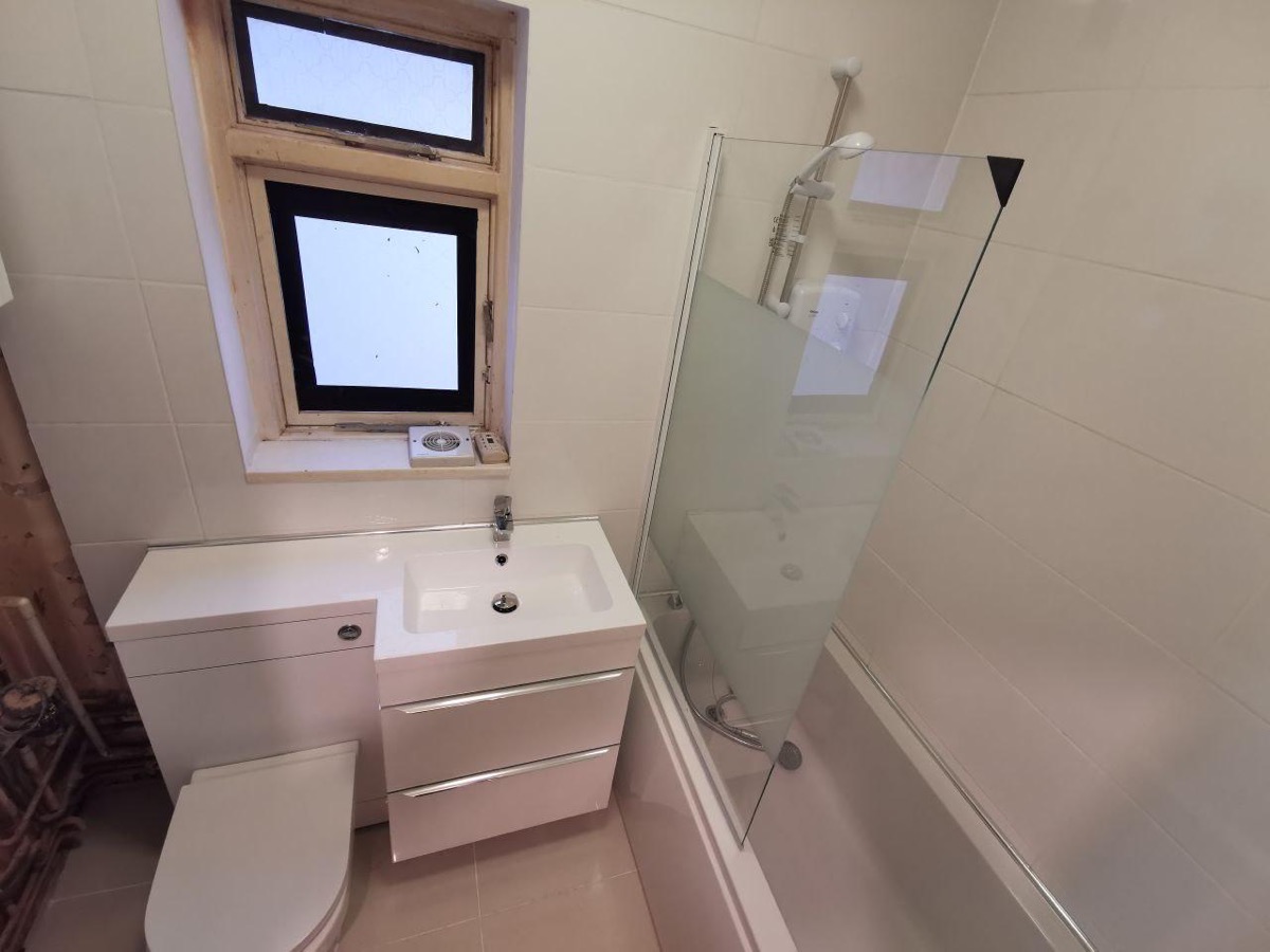 Finished bathroom with marble tiling